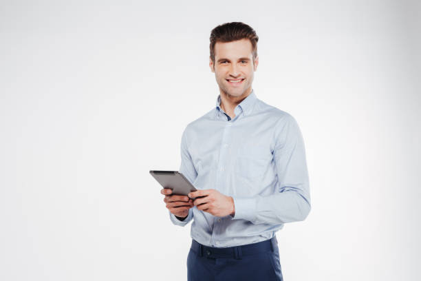 タブレットコンピュータを持つ笑顔のビジネスマン - business blue business person businessman ストックフォトと画像