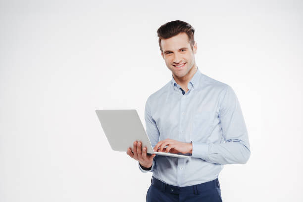 istock Happy business man holding laptop 1352110928