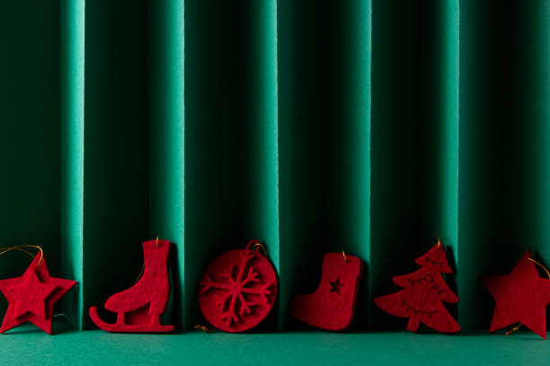 Red Christmas ornaments on green background