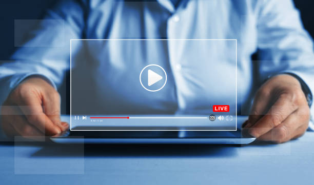 istock Online live stream window. Video streaming on internet concept. Woman watching a 
live stream. Live digital stream multimedia player. 1352111824