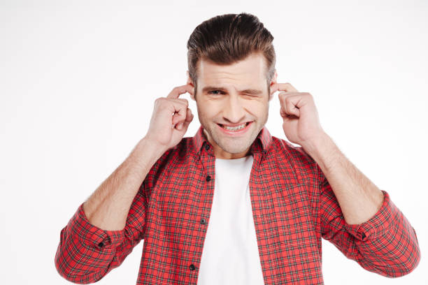 istock Young man covering his ears 1352111939