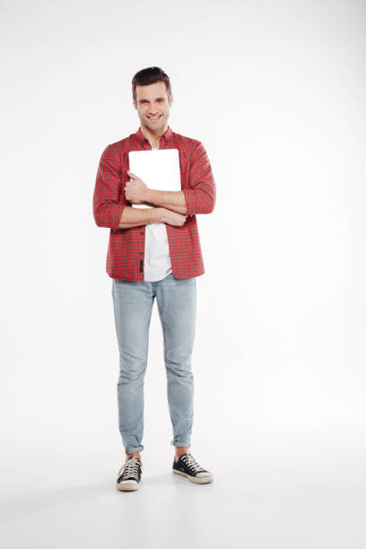 istock Vertical image of man embraces the laptop 1352112042