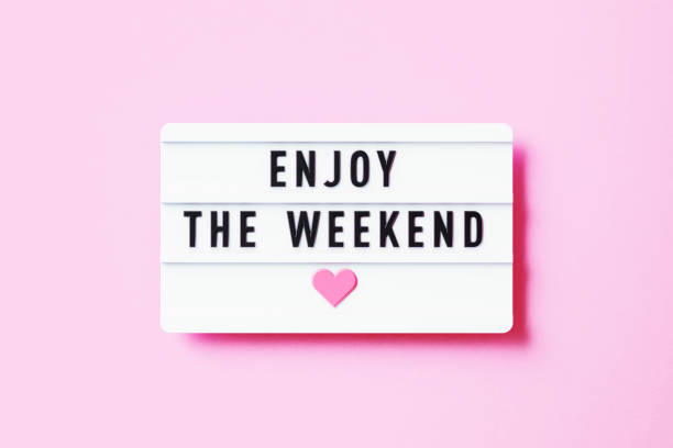 Enjoy The Weekend Written White Lightbox Sitting On Pink Background Enjoy The Weekend written white lightbox sitting on pink background. Horizontal composition with copy space. saturday stock pictures, royalty-free photos & images