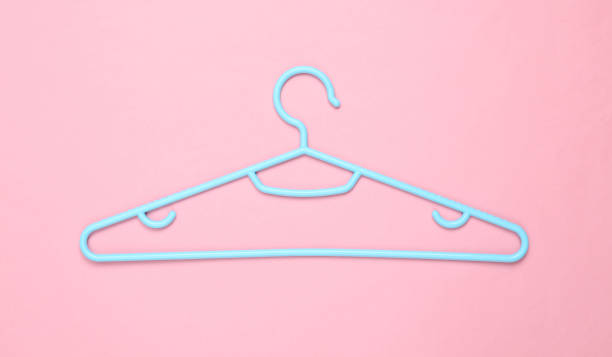 istock Blue Plastic hanger on pink background. Fashion layout. Flat lay. Top view 1352114758