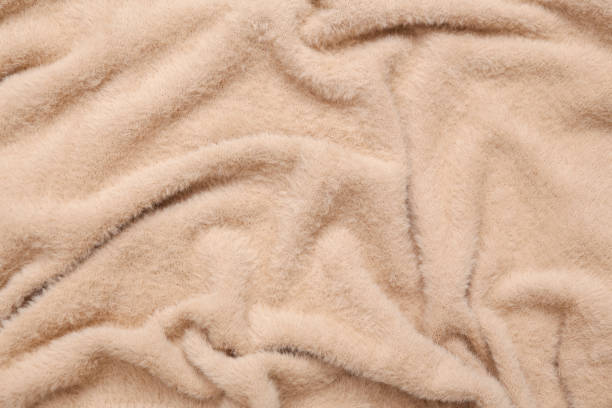 istock Soft beige fabric texture of sweater close up 1352114775