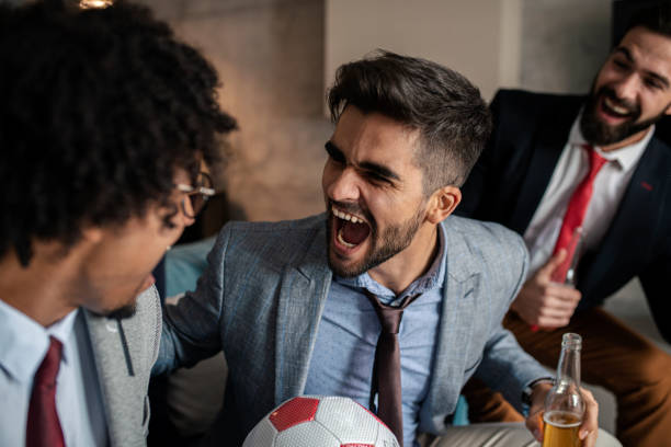 istock Friends watching sport on tv 1352114877