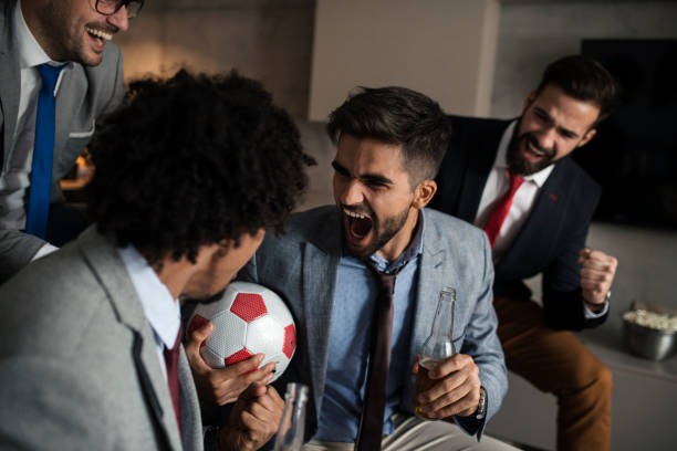istock Friends watching sport on tv 1352114881