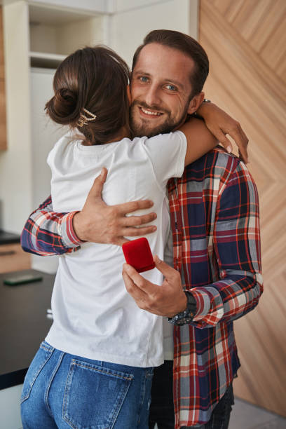 istock Happy adorable man with charming lady is surprised during romantic date in the kitchen 1352115044