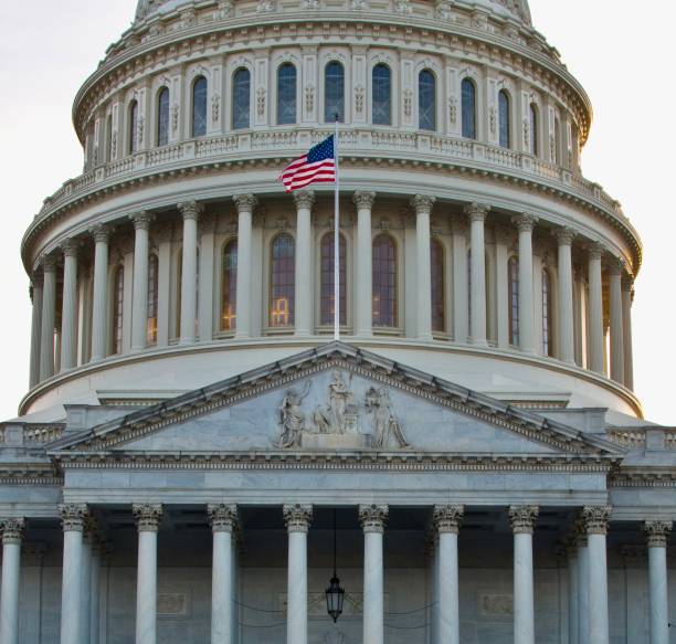 istock US Politics - Capitol Building & Flag 1352115901