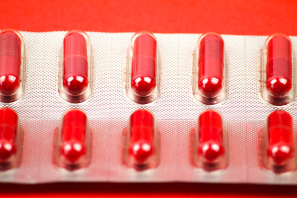 istock Blister pack of pills on red background 1352116260