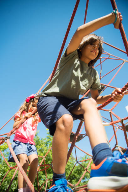 istock Happy sister and brother playing on playground 1352117738