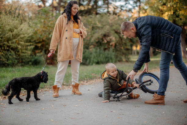 istock Father teaching son to ride bicycle 1352120276