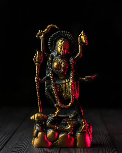 istock Kali goddess golden statue with red light on black background. vertical full from 1352120624