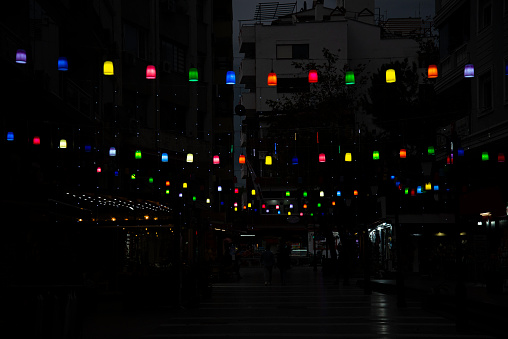 Colorful street lamps hung by rope