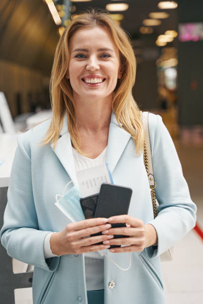 istock Joyous passenger with boarding ticket and foreign passport looking ahead 1352121740