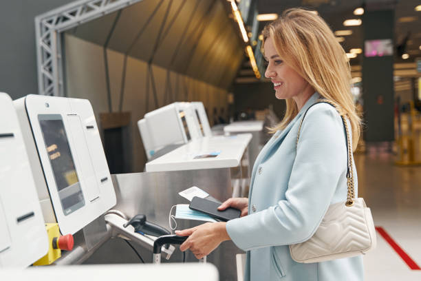 istock Smiling tourist checking in her baggage before flight 1352121754