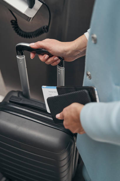 istock Passenger dropping off her baggage at airport terminal 1352121901