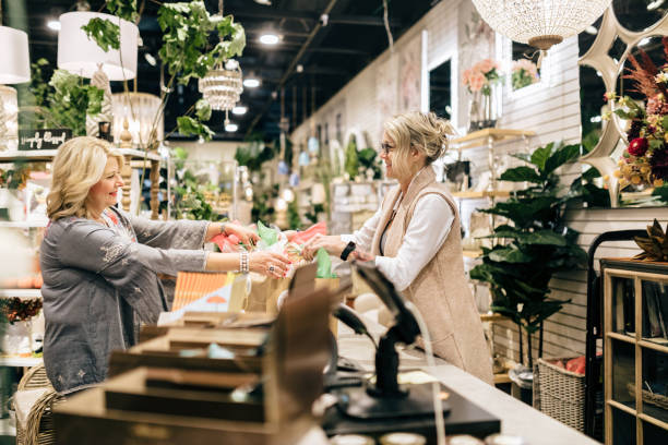 istock Employee Rings Up Customer For Her Purchase 1352122045