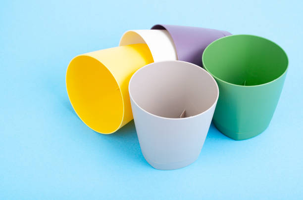 istock Bright blank flower pots on color paper background. 1352124091