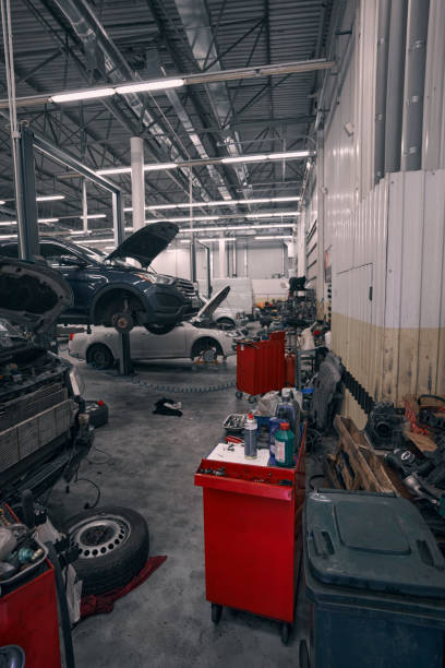 istock Car service workshop with automobiles in repair 1352125075
