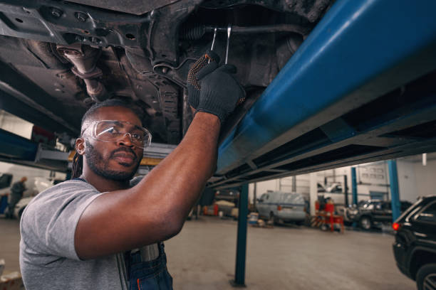 istock Professional auto repairman working with wrenches on track rod 1352125112