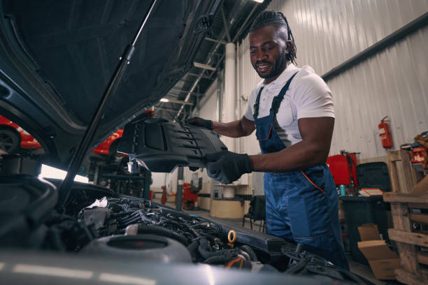 istock Man car mechanic taking off engine plastic cover 1352125138