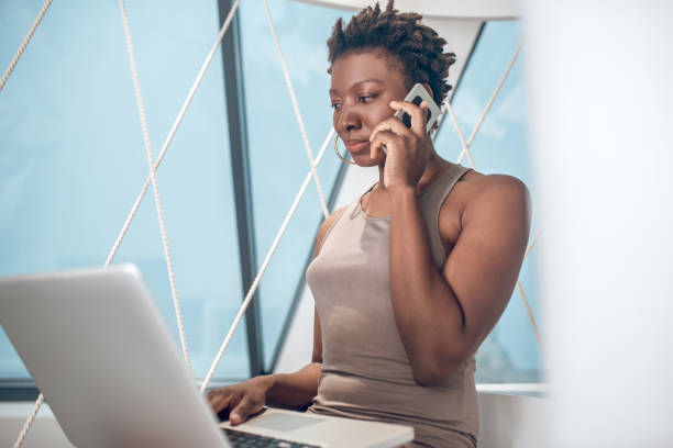 istock Confident young woman talking on the phone 1352125244