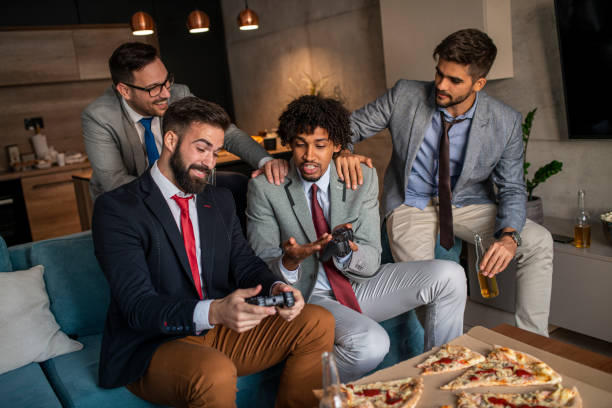 istock A group of young business man playing video games after work 1352126033