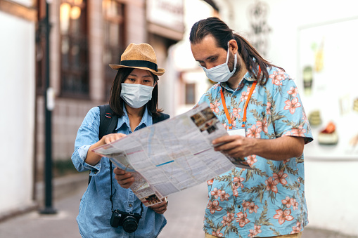 Japanese young woman asking for direction to tour guide