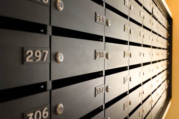 istock Mailboxes for letters and correspondence. Modern black mailboxes with numbers in the lobby of a residential or office building 1352127914