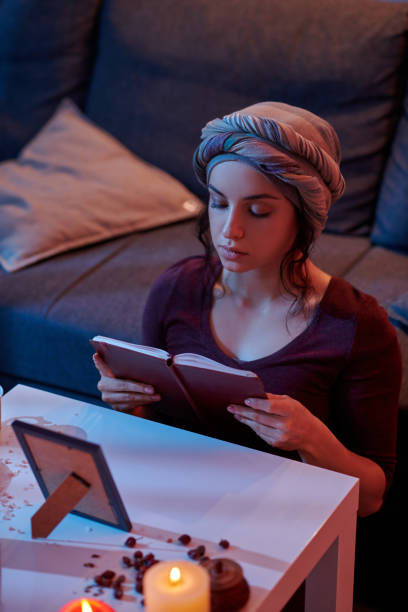 istock Beginner fortune-teller with an open handbook at the divination table 1352128818