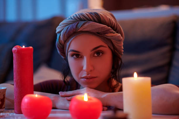 istock Tranquil soothsayer contemplating the candlelight before a magic ritual 1352128907