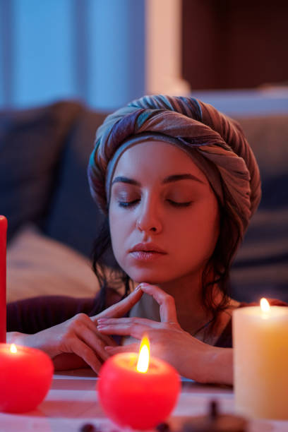 istock Pretty lady meditating with her eyes shut before a ritual 1352128914