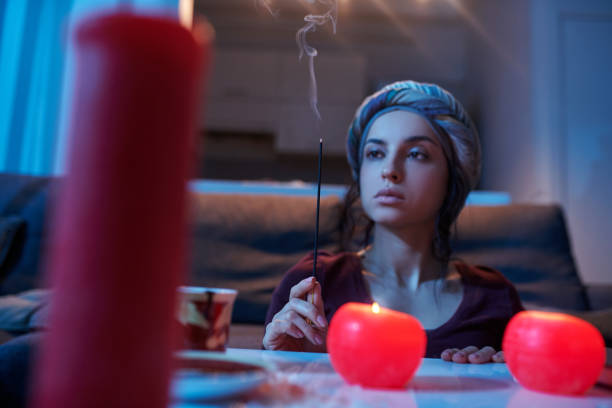 istock Serious female soothsayer performing a magic ritual 1352128926