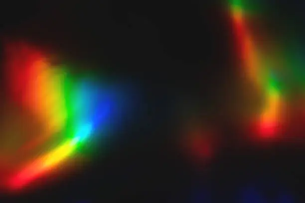 Photo of colorful rainbow crystal light leaks on black background