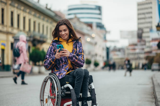 Woman with disability using a smartphone while out in the city