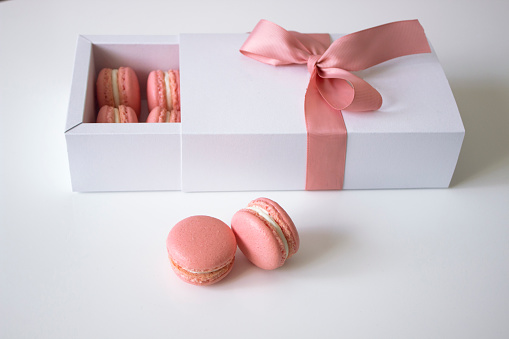 Macarons  in gift box, one color-rose. Close-up. White background.