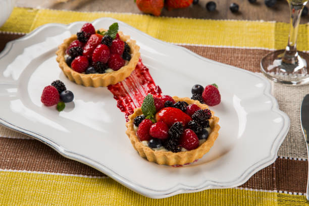 istock Two Fruit Pies with raspberries, blueberries and mulberries in a plate over the table. 1352132453