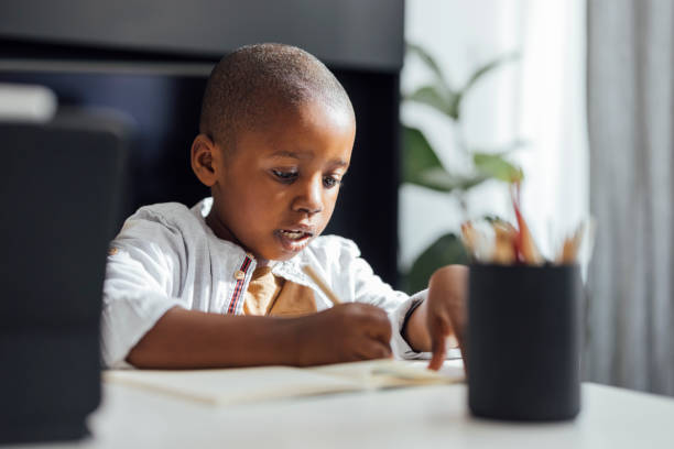 istock Little Boy Doing his Homework in a Living Room 1352132594