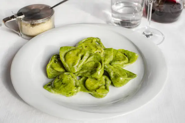 Tortelli balanzoni - italian green pasta filled with ricotta and spinach.