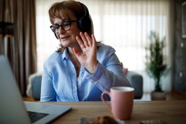 istock Smiling mature woman having video call 1352133527