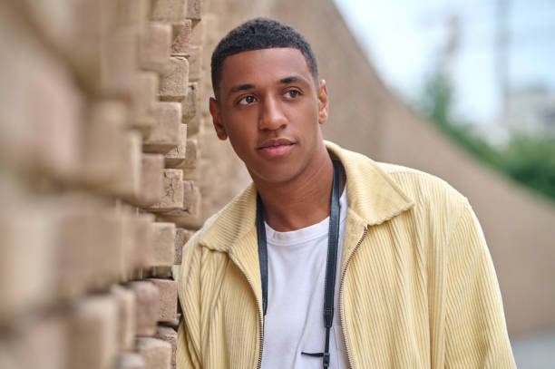 istock A young man standing near the brick wall 1352133851