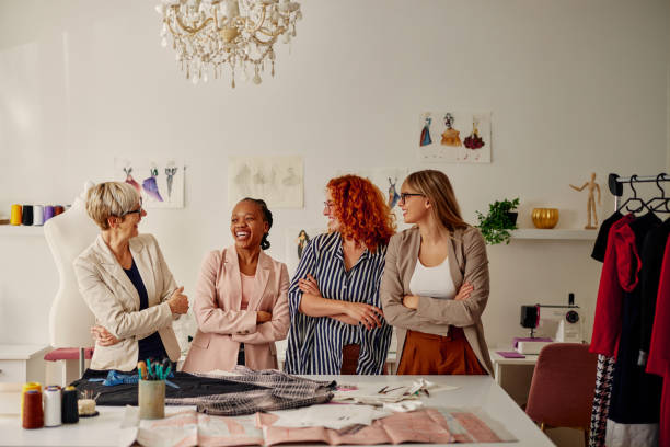 istock Four multiracial fashion designers working in studio 1352133880