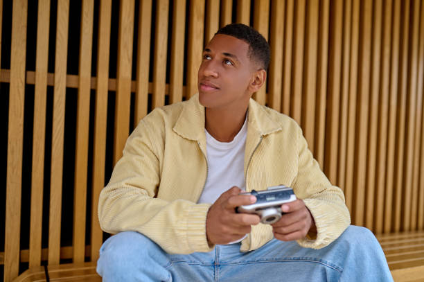 istock Young handsome photographer looking contented 1352133955