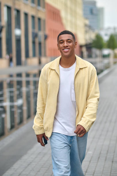 istock Young man in trendy clopthes smiling nicely 1352133981