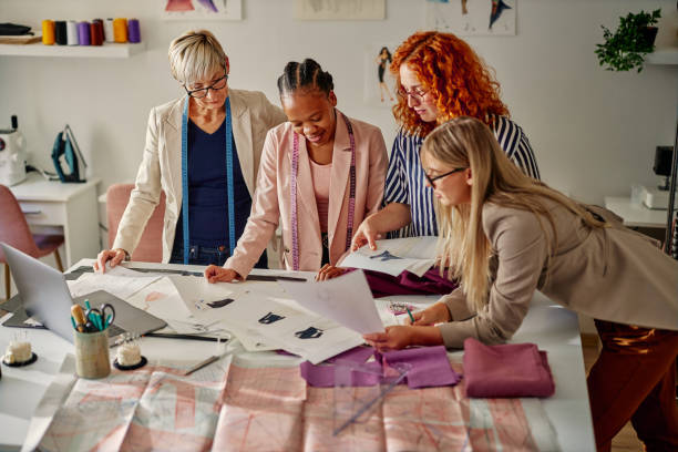 istock Colleagues working in fashion design studio 1352134539