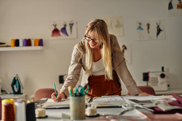 istock Female fashion designer working in office 1352134789