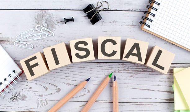 istock FISCAL text on wooden block with office tools on the wooden background 1352134868