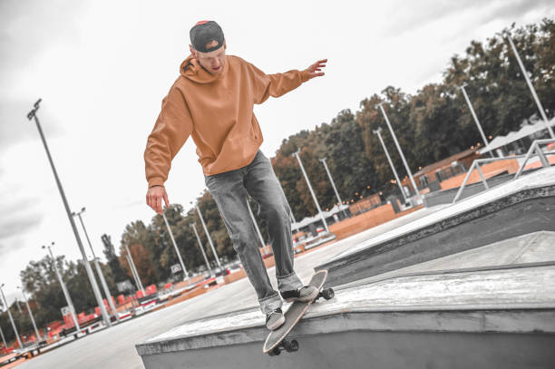 istock Guy on skateboard riding on border training balance 1352138175