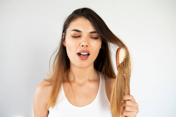 istock young woman have hair loss problem 1352138272